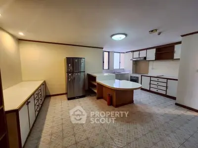 Spacious kitchen with modern appliances and ample storage in a well-lit open layout.