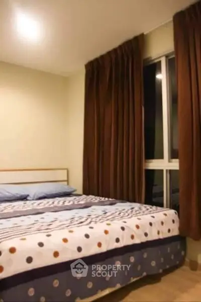 Cozy bedroom with large window and elegant curtains