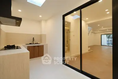 Modern open-layout kitchen with sleek design and adjacent living area