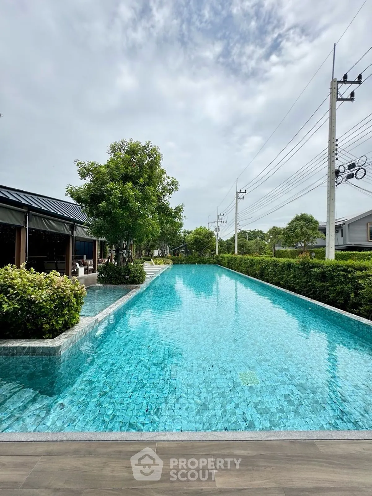 Luxurious outdoor pool with lush greenery and serene ambiance