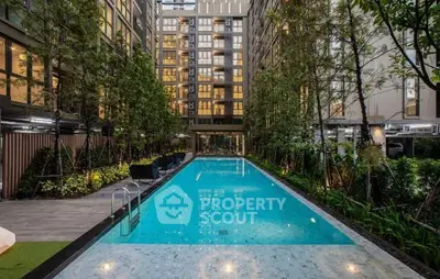 Luxurious apartment complex with stunning outdoor pool and lush greenery