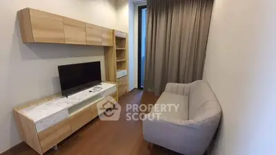 Modern living room with sleek wooden furniture and cozy gray sofa.