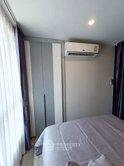 Modern bedroom with air conditioning and natural light from large window