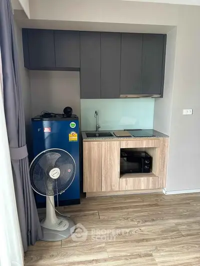 Modern compact kitchen with sleek cabinets and appliances in cozy apartment