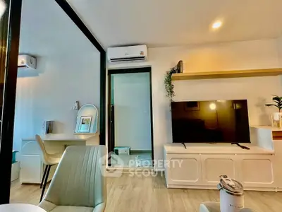 Modern living room with sleek furniture and large TV, featuring a cozy study nook and air conditioning.