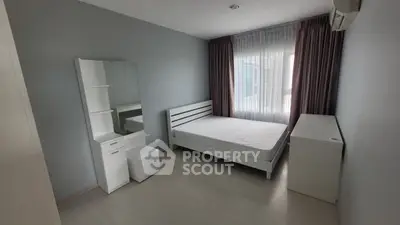 Modern minimalist bedroom with natural light and sleek furnishings