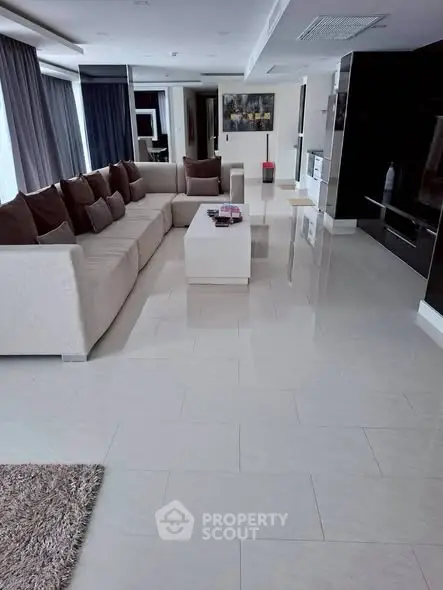 Spacious modern living room with elegant sofa and sleek tile flooring