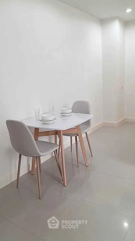 Minimalist dining area with sleek table and chairs in modern apartment