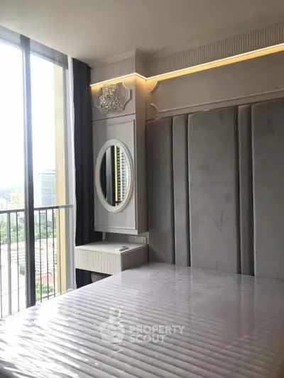 Luxurious bedroom with floor-to-ceiling windows and elegant decor in a high-rise apartment.