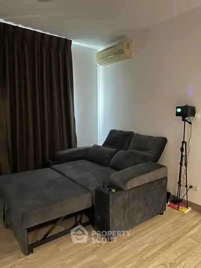 Cozy living room with plush sofa and modern decor, perfect for relaxation.