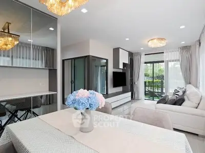 Modern living room with elegant decor and large windows opening to a balcony.