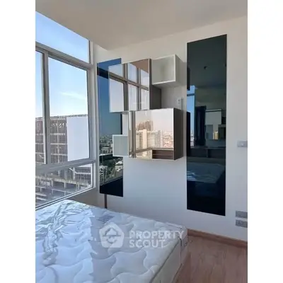 Modern bedroom with large windows and stylish wall decor in urban apartment