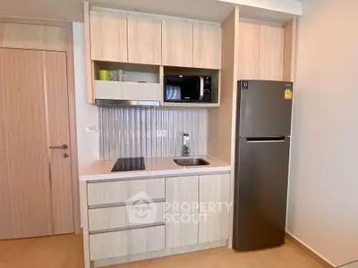 Modern compact kitchen with sleek cabinetry and stainless steel appliances