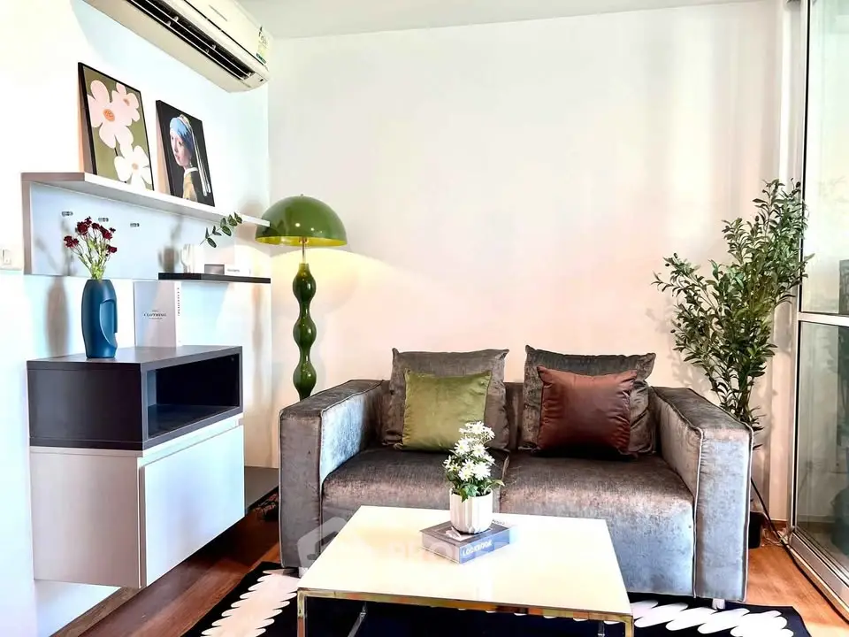 Stylish living room with modern decor, plush sofa, and elegant lighting in a cozy apartment setting.
