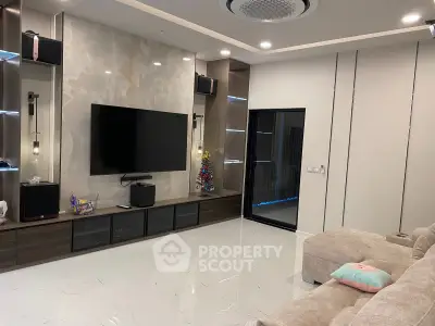 Luxurious modern living room with sleek entertainment center and plush seating, perfect for relaxation and entertainment.