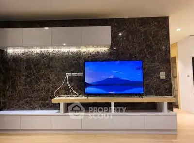 Modern living room with sleek TV setup and stylish wall design