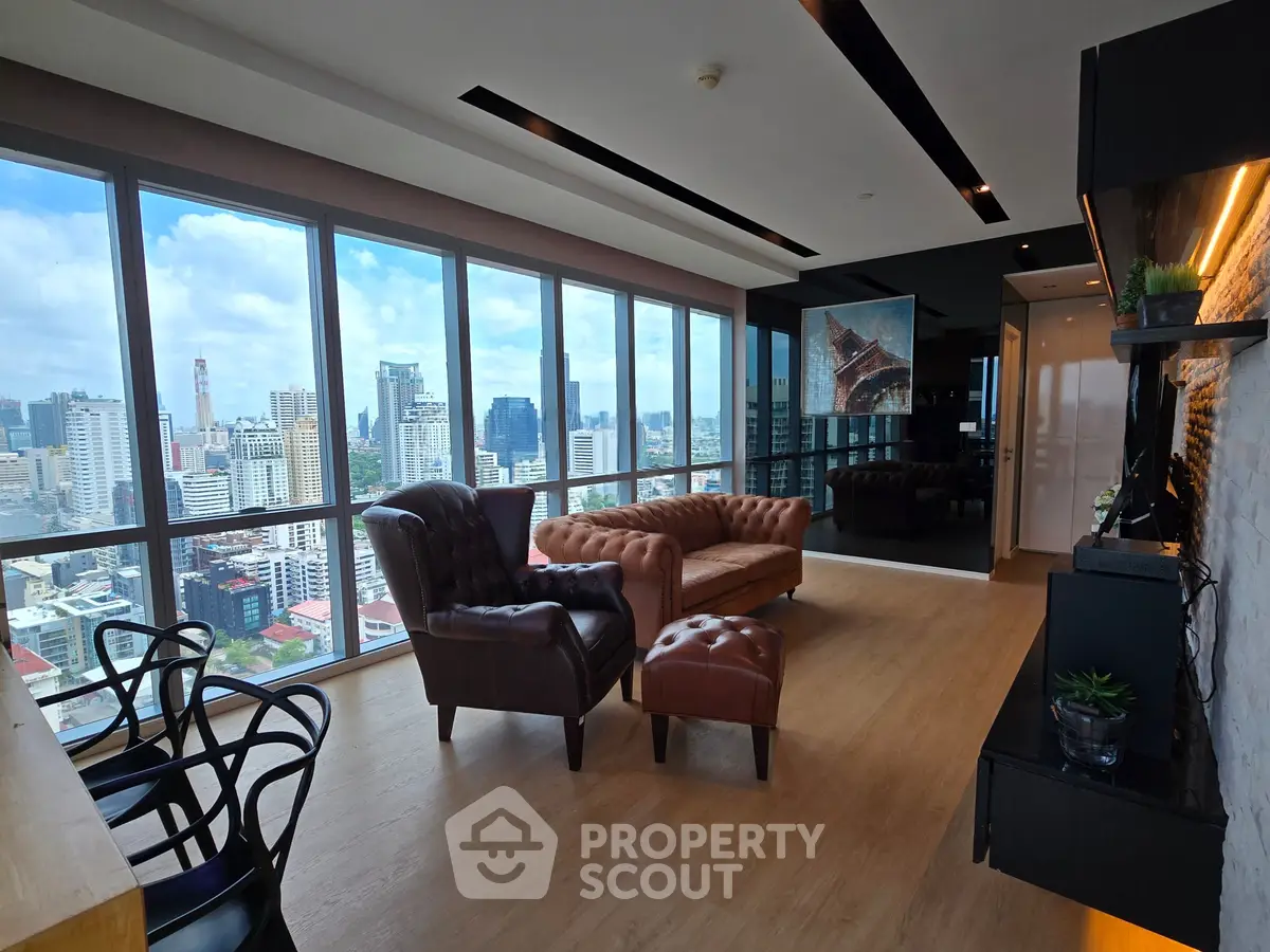 Luxurious high-rise living room with panoramic city views and modern furnishings.