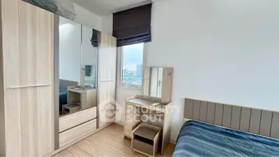 Modern bedroom with sleek wardrobe and vanity, offering a cozy and stylish living space.