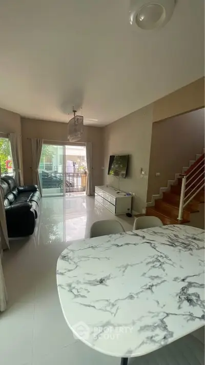 Spacious living room with modern decor and marble dining table