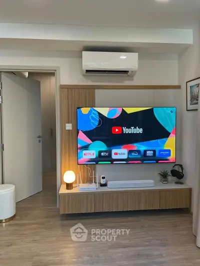 Modern living room with smart TV and stylish wooden furniture, perfect for entertainment and relaxation.