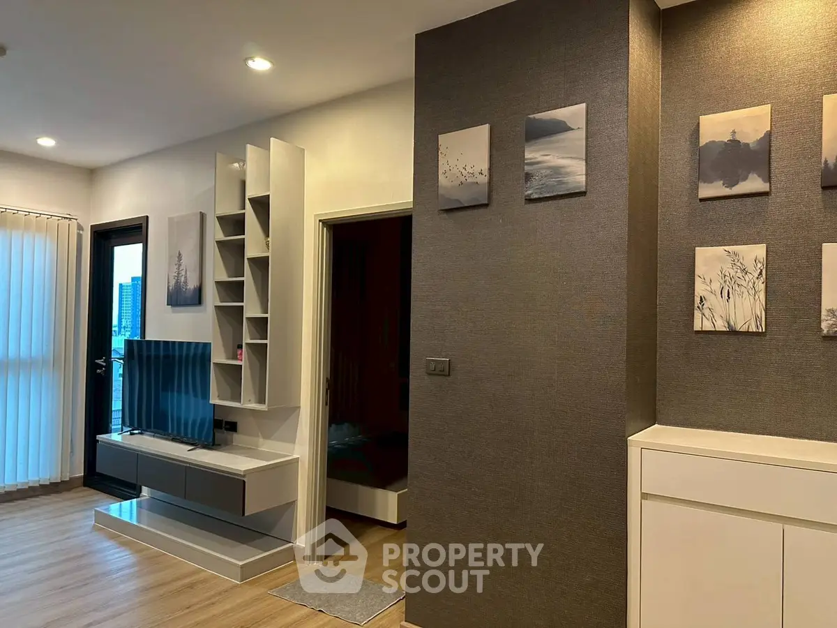 Modern living room with stylish decor and wall art, featuring a sleek TV setup.