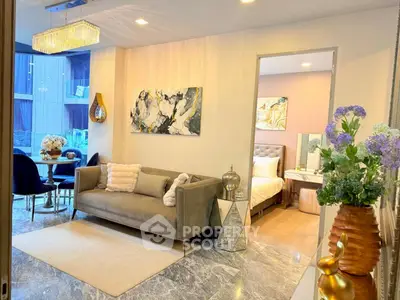 Luxurious living room with elegant decor and adjacent dining area in modern apartment.