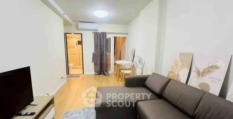 Modern living room with cozy sofa and stylish decor in a contemporary apartment.