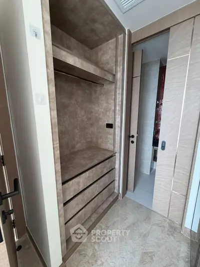 Modern walk-in closet with sleek design and ample storage space