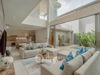 Luxurious open-plan living room with modern kitchen and poolside view, perfect for entertaining.