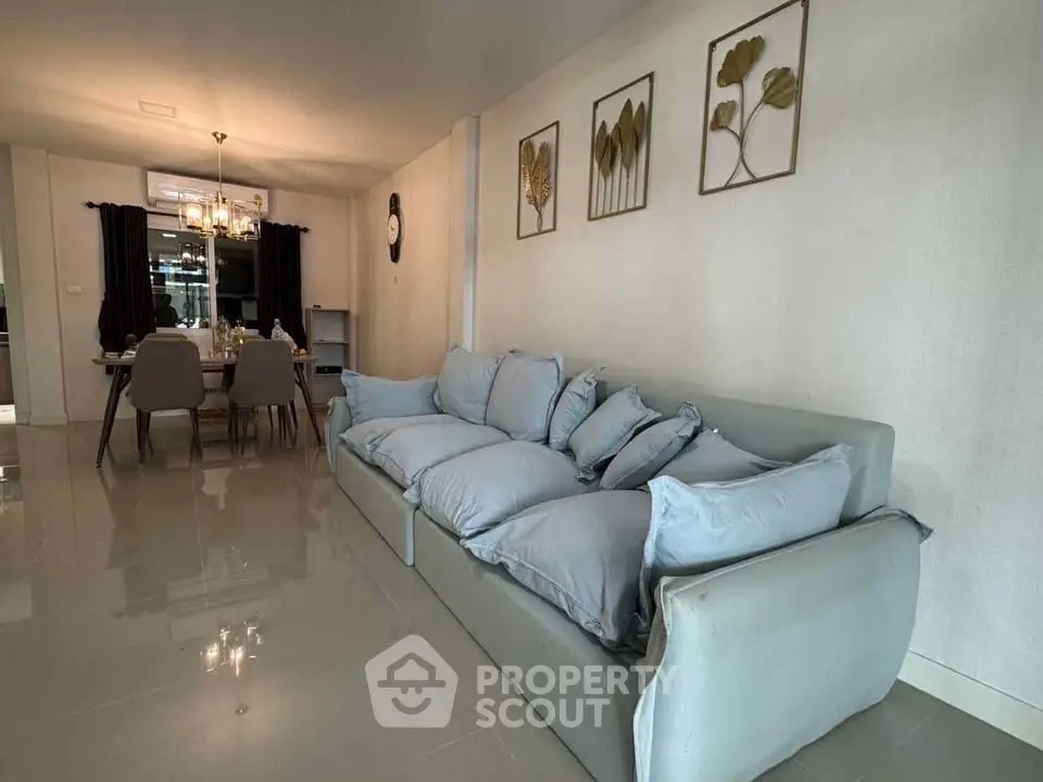 Spacious living room with modern decor and elegant dining area