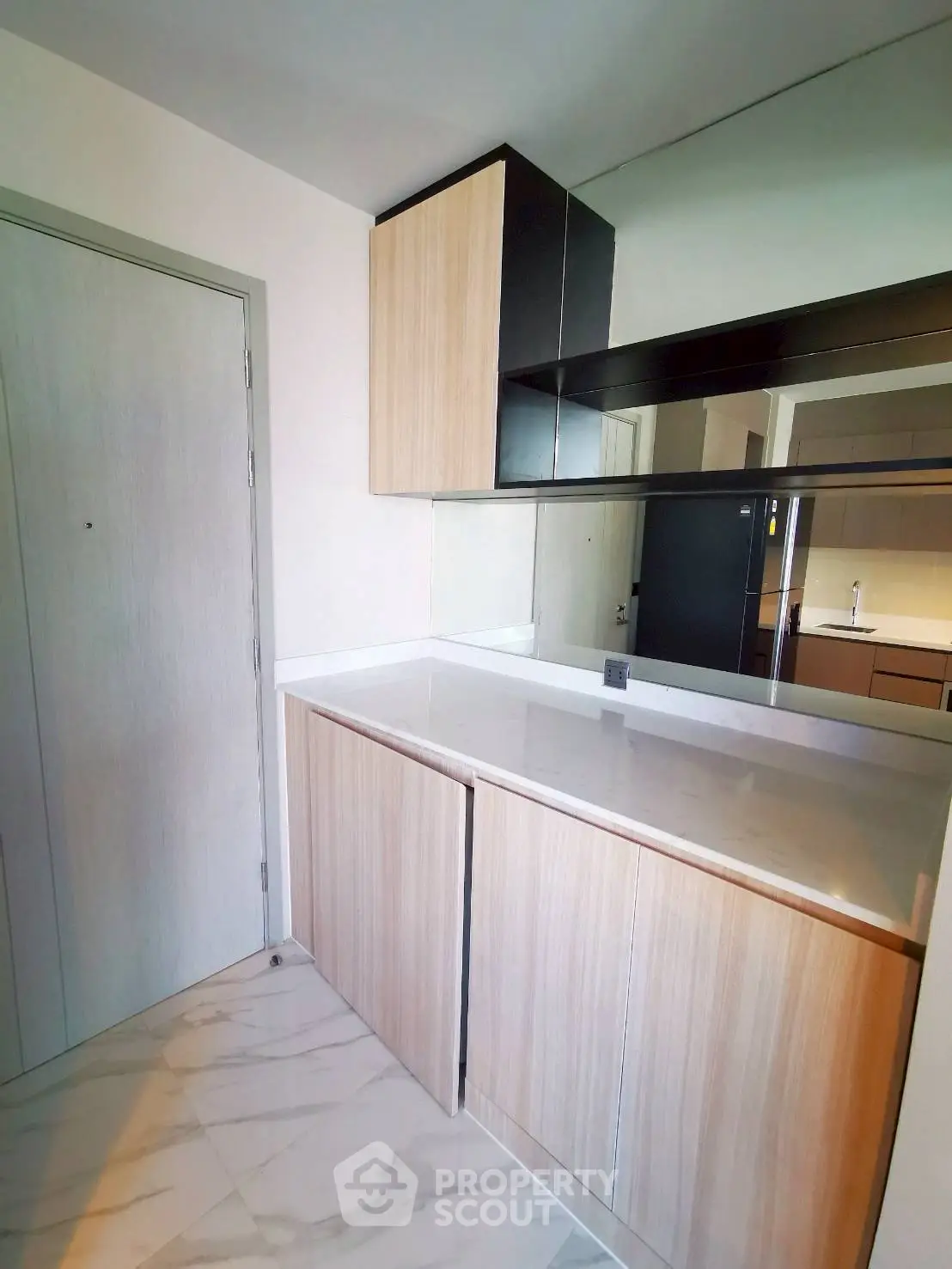 Modern storage area with sleek cabinetry and marble flooring