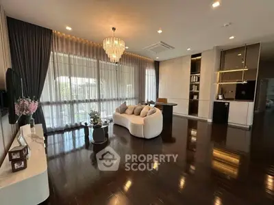 Luxurious living room with elegant chandelier and floor-to-ceiling windows