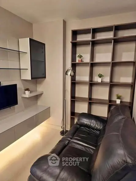 Modern living room with sleek shelving and leather sofa