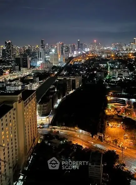 Stunning city skyline view at night with vibrant lights and urban landscape.