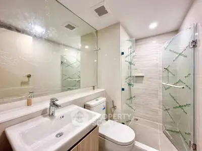 Modern bathroom with sleek fixtures and glass shower enclosure