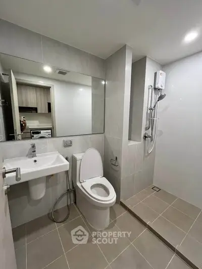 Modern bathroom with sleek fixtures and spacious shower area
