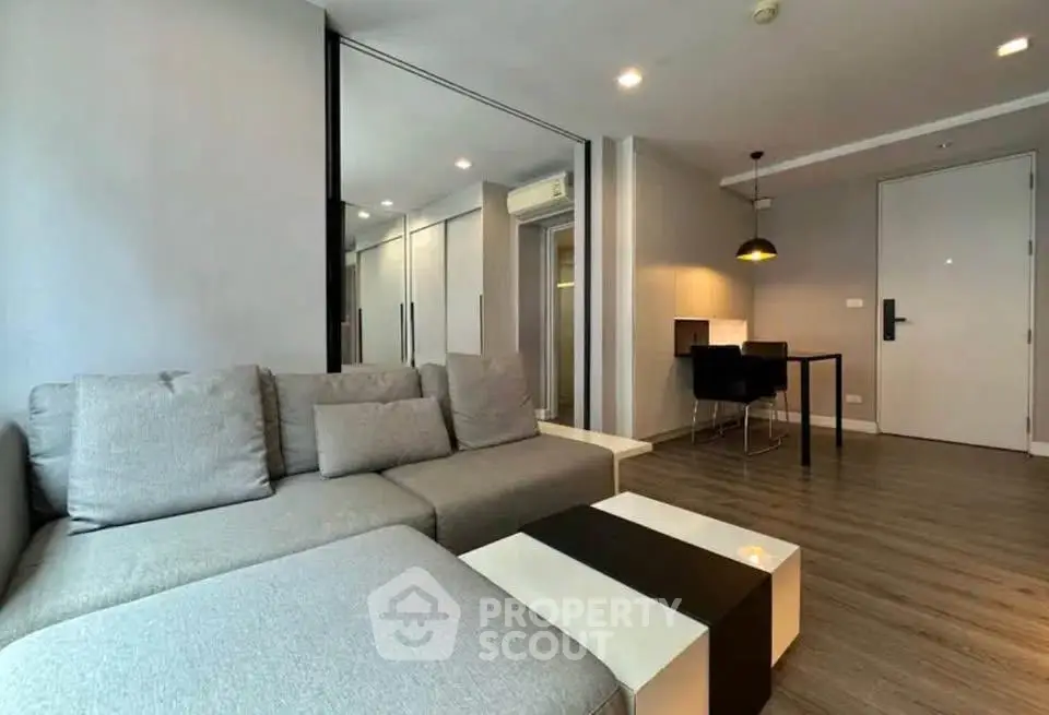Modern living room with gray sofa and stylish decor in a contemporary apartment.