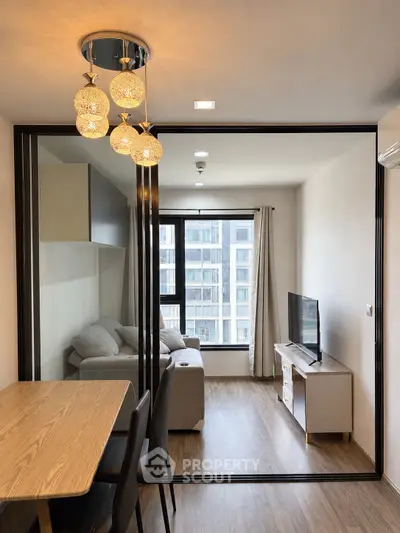 Modern living room with glass partition and elegant lighting in a stylish apartment.