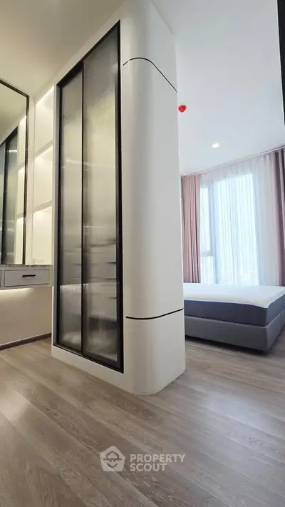 Modern bedroom with sleek design and floor-to-ceiling windows for natural light.