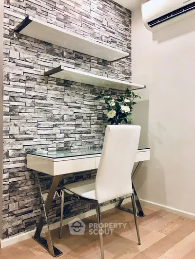 Modern study area with sleek desk, chair, and decorative stone wall.