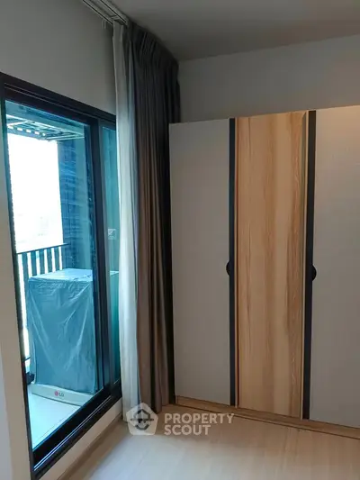 Modern bedroom with wardrobe and balcony access in stylish apartment