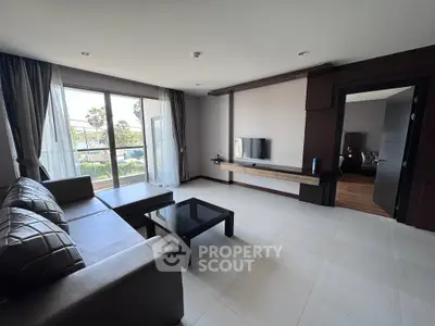 Spacious living room with modern decor and large windows offering natural light.