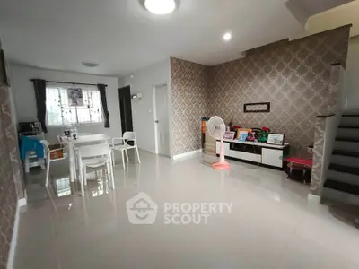 Spacious living room with modern decor and elegant wallpaper