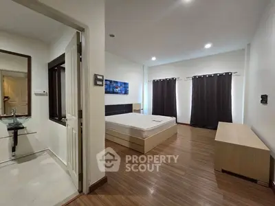 Spacious bedroom with modern decor and natural light