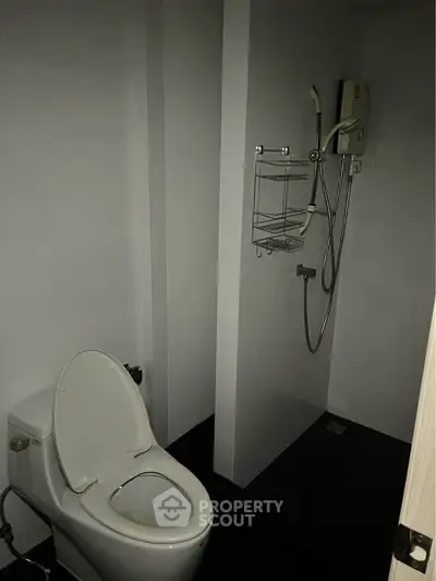 Compact bathroom with toilet and shower in minimalist design