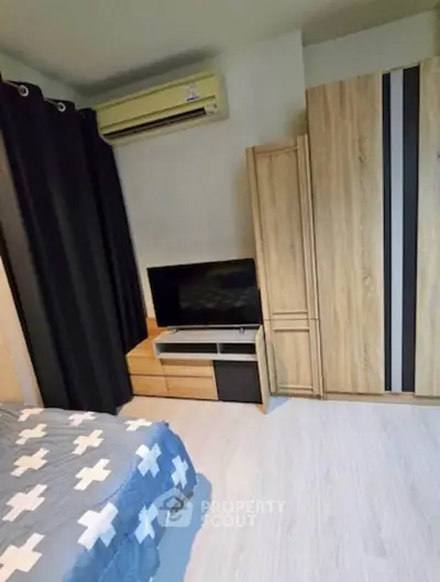 Cozy bedroom with modern furniture and air conditioning, perfect for comfortable living.