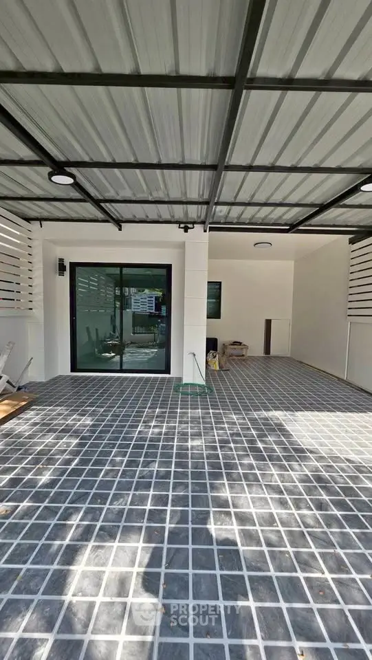 Spacious modern carport with sleek design and ample parking space.
