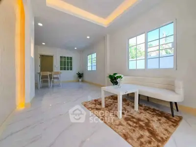 Spacious modern living room with elegant white decor and natural light