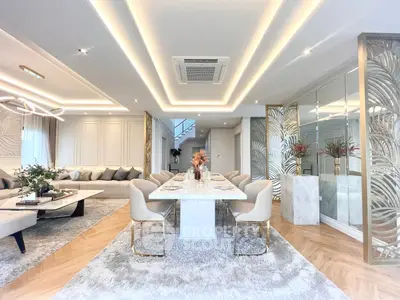 Luxurious open-plan living and dining area with elegant decor and modern lighting.