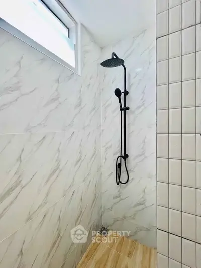 Modern bathroom with elegant marble tiles and sleek shower design